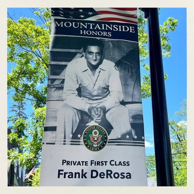 The Mountainside Honors banner outside the shop: Private First Class Frank DeRosa, United States Army
